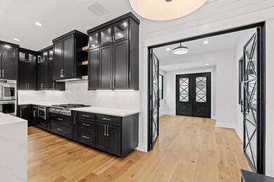 Kitchen with glass insert cabinets, visible vents