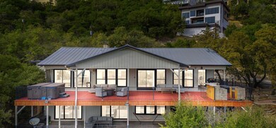 Rear view of house with metal roof, a deck, and a