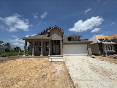 View of front of property featuring driveway, bric