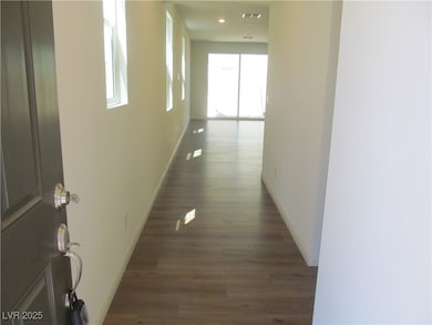 Hallway featuring baseboards and dark wood-type fl