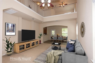 Carpeted living room with a high ceiling, arched 