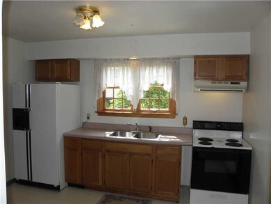 Kitchen. Wood Cabinets in Kitchen and Double Windo