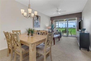 Dining area with ceiling fan with notable chandeli