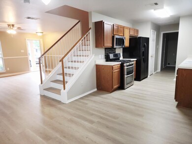 Kitchen with stainless steel appliances, light wo