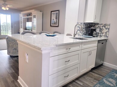 Kitchen with kitchen peninsula, dishwasher, decora