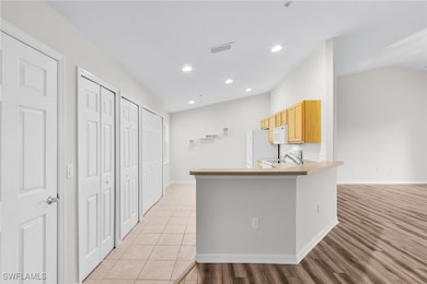 Kitchen with light brown cabinets, sink, kitchen p