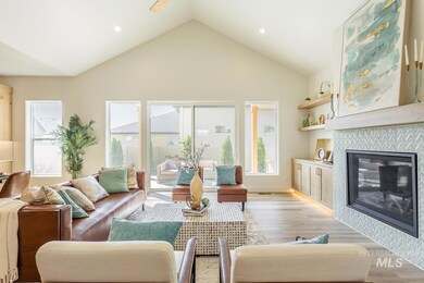 Living room featuring light wood-style floors, healthy amount of natural light, a fireplace, high vaulted ceiling, and recessed lighting