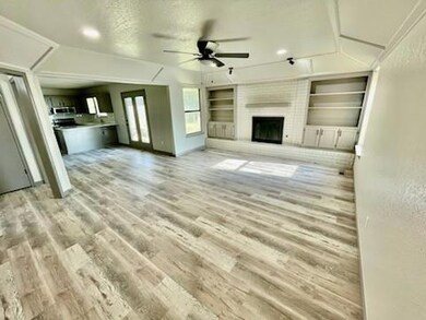 Unfurnished living room featuring a large fireplac