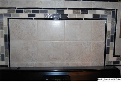 Tiled back splash above the stove.