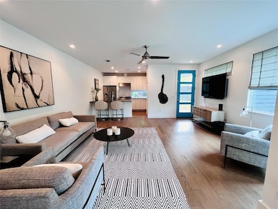 Living area featuring wood finished floors, a cei