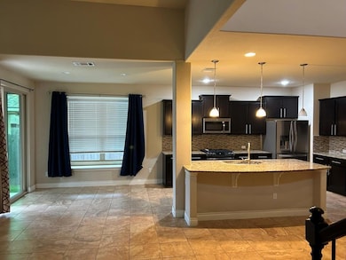Kitchen featuring hanging light fixtures, stainless steel appliances, dark cabinets, plenty of natural light, and recessed lighting