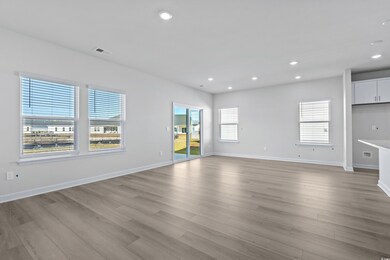 Unfurnished living room with a wealth of natural l