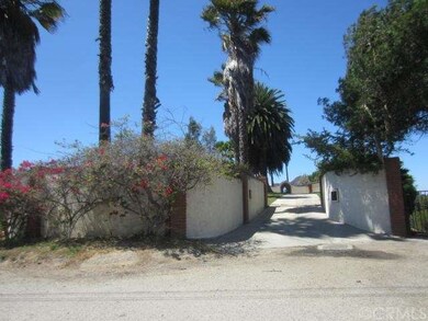 View looking northwesterly at the gated front entr