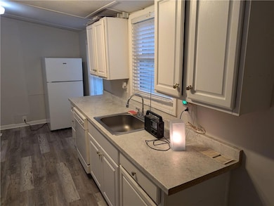 Kitchen featuring white cabinets, dark hardwood / 