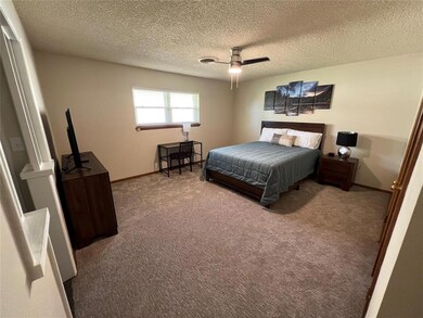 Bedroom featuring a textured ceiling, carpet floor