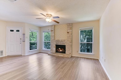 Unfurnished living room featuring a textured ceil