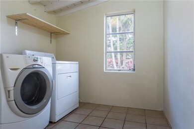 Side load washer in tiled utility room