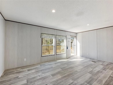 Empty room with crown molding, wood finished floor