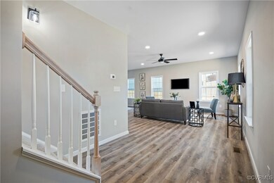 Living area featuring stairway, baseboards, a ceil