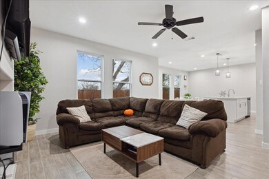 Living room featuring sink, ceiling fan, and light