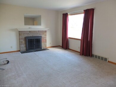 Spacious living room with gas fireplace and pictur