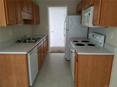 Galley kitchen with stainless steel sink. Applianc