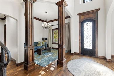 Entryway featuring ornamental molding, a towering 