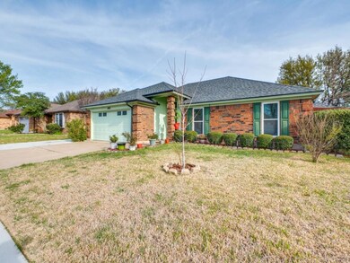 Ranch-style home with brick siding, a front yard, 