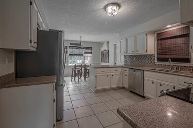 Kitchen with hanging light fixtures, stainless ste