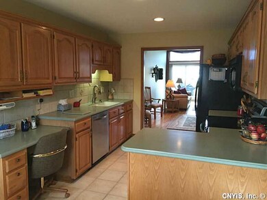 Kitchen Tile floor and back splash adorn the kitch