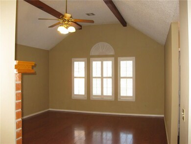 Huge living room with beams on the ceiling.