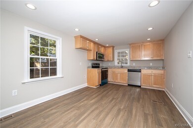 The kitchen boasts LED lighting, LVP flooring, gra