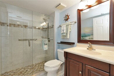 Bathroom with vanity and a shower stall
