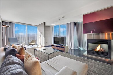 Living area with a glass covered fireplace, floor