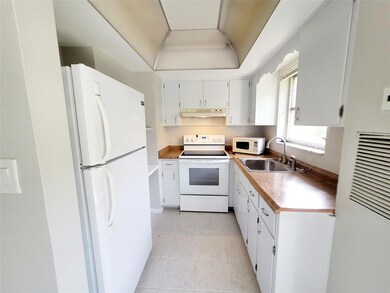 Kitchen offers white cabinets and white appliances