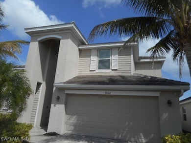 View of front facade featuring a garage and stucco