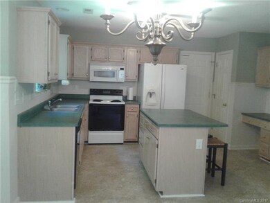 Kitchen with island, desk and pantry. Appliances c