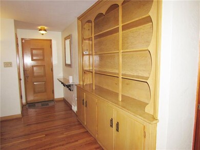 The Entry boasts Built-in Shelves & Cabinets that 