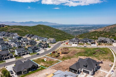 Aerial view of residential area featuring mountains and property boundaries highlighted
