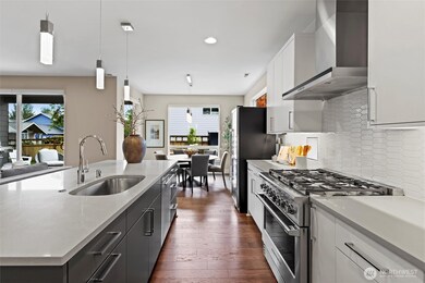 Chefs kitchen with oversized Quartz Island, Huntwood sleek cabinetry, Fisher & Paykel appliances and walk-in pantry.