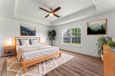 Master bedroom with tray ceiling is a restful retr