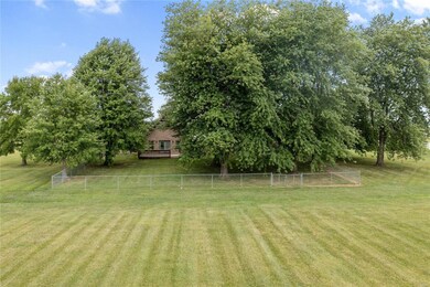 Back of the house, with a partially fenced yard.