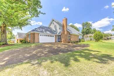 View of front of house with a front lawn and a gar