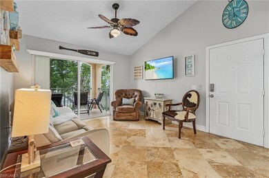 Living room with a ceiling fan, a textured ceiling, and high vaulted ceiling