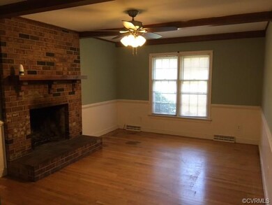 Den with brick fireplace