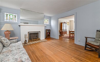 Living room features brick gas log fireplace flank