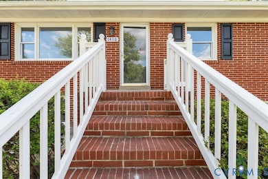 Property entrance featuring brick siding