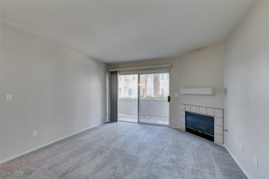 Unfurnished living room featuring carpet flooring and a fireplace