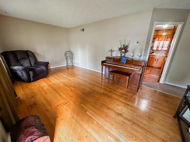 Living area with hardwood / wood-style floors