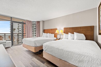Bedroom featuring floor to ceiling windows, access to outside, wood finished floors, and a textured ceiling